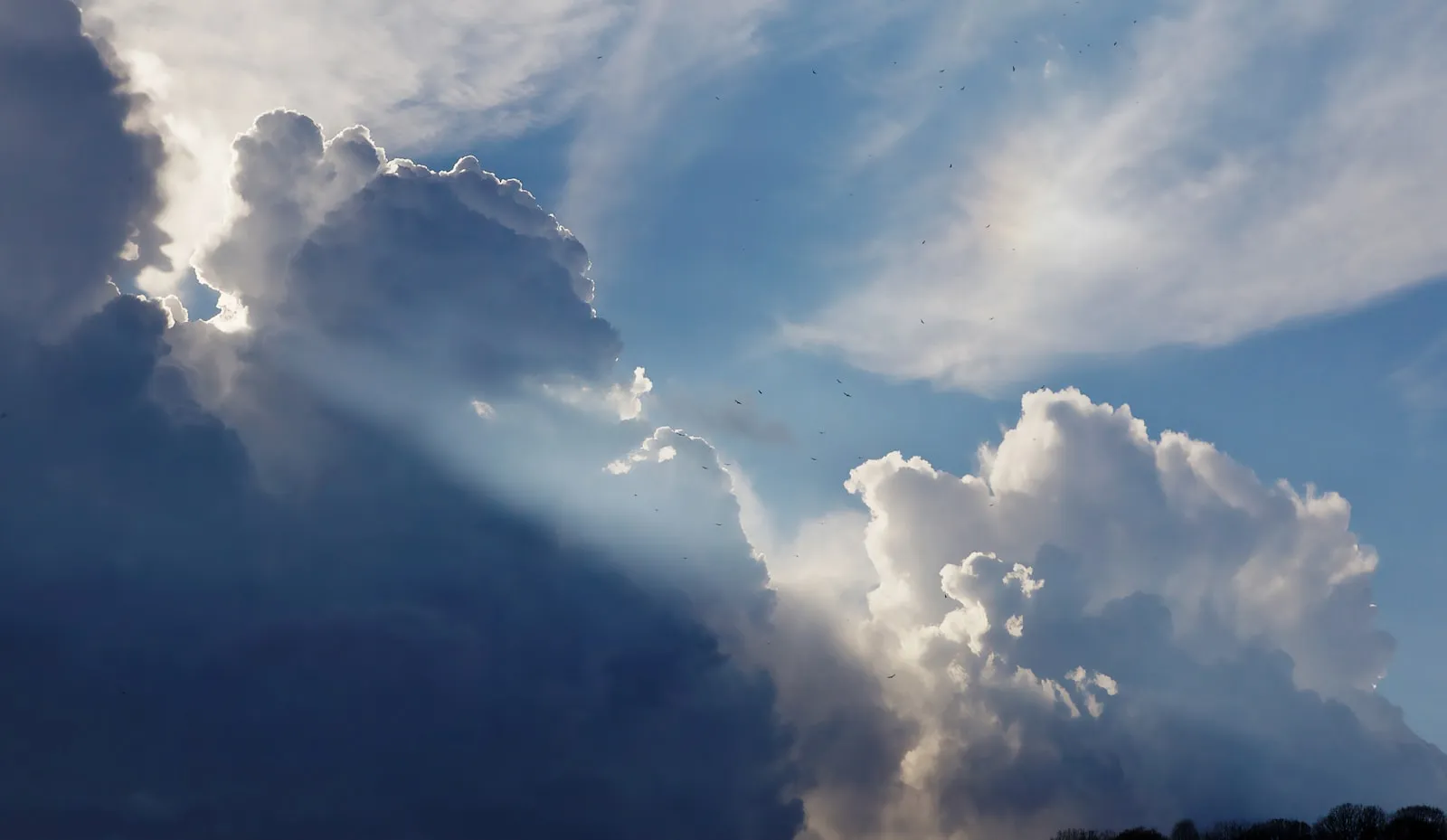 Sun rays breaking through towering clouds